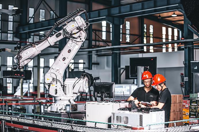 two workers in a factory working on a project